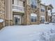 Back exterior with sliding door entrance, a small balcony with snowy grounds provides outdoor living at 7440 S Blackhawk St # 9-108, Englewood, CO 80112