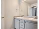 Bathroom with double sink vanity, large mirror, and neutral color scheme at 7440 S Blackhawk St # 9-108, Englewood, CO 80112