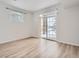 Bedroom boasts neutral walls, light wood-look flooring and a sliding glass door at 7440 S Blackhawk St # 9-108, Englewood, CO 80112