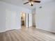 Bright bedroom with light wood-look flooring, white doors, and an ensuite bathroom at 7440 S Blackhawk St # 9-108, Englewood, CO 80112