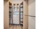 A custom closet with adjustable shelving, drawers, and upper cabinets offer organization and storage solutions at 7440 S Blackhawk St # 9-108, Englewood, CO 80112