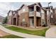 Charming exterior featuring stone accents, private balconies, and well-maintained landscaping at 7440 S Blackhawk St # 9-108, Englewood, CO 80112