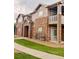 Charming exterior featuring stone accents, private balconies, and well-maintained landscaping at 7440 S Blackhawk St # 9-108, Englewood, CO 80112