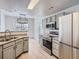 Kitchen with stainless steel appliances, light countertops, and modern lighting fixture at 7440 S Blackhawk St # 9-108, Englewood, CO 80112