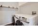 Laundry room with full-size washer and dryer and floating shelves at 7440 S Blackhawk St # 9-108, Englewood, CO 80112