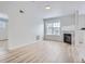 Bright living room featuring a stone-accented fireplace and large window, creating a cozy and inviting space at 7440 S Blackhawk St # 9-108, Englewood, CO 80112