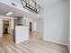 Open living space with modern light fixture, view to kitchen and laundry, and neutral color palette at 7440 S Blackhawk St # 9-108, Englewood, CO 80112