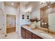 Well-lit bathroom features a double sink vanity, decorative accents, and a spacious walk-in shower at 903 W 129Th Pl, Westminster, CO 80234