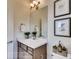 Bathroom features a modern vanity, framed art, and updated lighting at 903 W 129Th Pl, Westminster, CO 80234