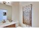 Stylish half-bathroom with modern vanity, decorative mirror, lighting, and elegant artwork at 903 W 129Th Pl, Westminster, CO 80234