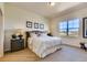 Comfortable bedroom with a cozy bed, side tables with lamps, and a view from the window at 903 W 129Th Pl, Westminster, CO 80234