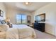 Cozy bedroom featuring a plush bed, dark wood dresser, and a view of the neighborhood at 903 W 129Th Pl, Westminster, CO 80234