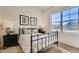 Cozy bedroom features large window, plush bedding, and stylish nightstands at 903 W 129Th Pl, Westminster, CO 80234