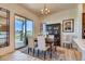 Bright dining area with sliding glass doors, modern chandelier, and decorative wood cabinet at 903 W 129Th Pl, Westminster, CO 80234