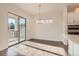 Dining area features sliding glass doors and modern chandelier at 903 W 129Th Pl, Westminster, CO 80234