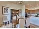 Elegant dining room featuring modern light fixture, stylish chairs, and decorative wood cabinet at 903 W 129Th Pl, Westminster, CO 80234
