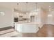 Bright kitchen featuring white cabinets, a large island, modern appliances, and hardwood flooring at 903 W 129Th Pl, Westminster, CO 80234