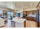 Bright kitchen boasts sleek countertops, stainless appliances, a breakfast bar, and an adjacent dining area at 903 W 129Th Pl, Westminster, CO 80234