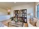 Inviting living room with a large glass coffee table, decorative shelving, and comfortable seating at 903 W 129Th Pl, Westminster, CO 80234
