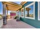 Inviting covered porch with comfortable seating, stone accents, and scenic community views at 903 W 129Th Pl, Westminster, CO 80234