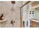 Walk-in shower features decorative tiles, rainfall showerhead, and a built-in niche for toiletries at 903 W 129Th Pl, Westminster, CO 80234