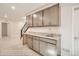 Basement wet bar with upper and lower gray cabinets and a stainless steel sink at 903 W 129Th Pl, Westminster, CO 80234