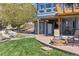 A backyard features a stone fire pit, water feature, and an exterior shed at 9895 Wyecliff Dr, Highlands Ranch, CO 80126