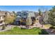 Back exterior view of home with decks, patio, fire pit, and lush lawn at 9895 Wyecliff Dr, Highlands Ranch, CO 80126