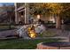 Backyard water feature, fire pit, and outdoor seating area with lighting at 9895 Wyecliff Dr, Highlands Ranch, CO 80126