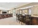 Finished basement bar with seating and an open layout to the entertainment area at 9895 Wyecliff Dr, Highlands Ranch, CO 80126
