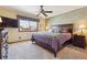 Spacious bedroom with a ceiling fan, large window, a comfortable bed, and a TV at 9895 Wyecliff Dr, Highlands Ranch, CO 80126