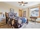 Bright bedroom featuring a decorative quilt, ceiling fan, and a charming window with natural light at 9895 Wyecliff Dr, Highlands Ranch, CO 80126