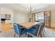 Inviting dining room with wood table and chairs and view to the sun room at 9895 Wyecliff Dr, Highlands Ranch, CO 80126