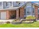 Beautiful home with meticulous landscaping, brick accents, and a charming entrance with a cozy seating area at 9895 Wyecliff Dr, Highlands Ranch, CO 80126