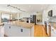 Open-concept kitchen featuring a large island with bar seating and modern appliances at 9895 Wyecliff Dr, Highlands Ranch, CO 80126