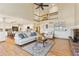Open-concept living space with hardwood floors, fireplace, and views of the kitchen and upper floor at 9895 Wyecliff Dr, Highlands Ranch, CO 80126