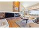 Spacious living room has hardwood floors, large windows with views, and a brick fireplace at 9895 Wyecliff Dr, Highlands Ranch, CO 80126