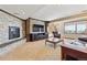 Basement living room with stone fireplace, large windows, and comfortable seating at 9895 Wyecliff Dr, Highlands Ranch, CO 80126