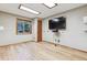 Versatile room with a window, a mounted TV, and laminate flooring at 9895 Wyecliff Dr, Highlands Ranch, CO 80126
