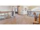 Upstairs landing with railing overlooking the first floor, carpeted floor and a view of another bedroom at 9895 Wyecliff Dr, Highlands Ranch, CO 80126