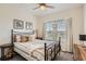 Comfortable bedroom with neutral tones, a ceiling fan, and lots of natural light from the windows at 9486 Elmhurst Ln # D, Highlands Ranch, CO 80129