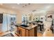 Well-appointed kitchen island with stainless appliances opens to dining area at 9486 Elmhurst Ln # D, Highlands Ranch, CO 80129
