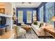 Cozy living room with hardwood floors, ample natural light, and a charming fireplace at 9486 Elmhurst Ln # D, Highlands Ranch, CO 80129