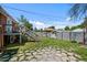 Backyard featuring a stone pathway, well-kept lawn, and detached garage, perfect for outdoor living and storage at 2430 S Ogden St, Denver, CO 80210