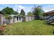 Backyard with a lush green lawn, storage shed, and privacy fence, offering a private and functional outdoor space at 2430 S Ogden St, Denver, CO 80210