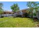 The home's backyard features a large lawn, wooden deck, and a partial privacy fence, perfect for outdoor entertaining at 2430 S Ogden St, Denver, CO 80210