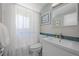 Clean bathroom with white vanity, tile accents, and a shower/tub combo at 2430 S Ogden St, Denver, CO 80210