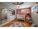 Bright Bedroom featuring a white crib, colorful rug, and lots of natural light at 2430 S Ogden St, Denver, CO 80210