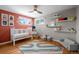 Cozy Bedroom featuring hardwood floors, white crib, and playful decor at 2430 S Ogden St, Denver, CO 80210