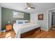 Comfortable bedroom with hardwood floors, a ceiling fan, and neutral wall colors at 2430 S Ogden St, Denver, CO 80210